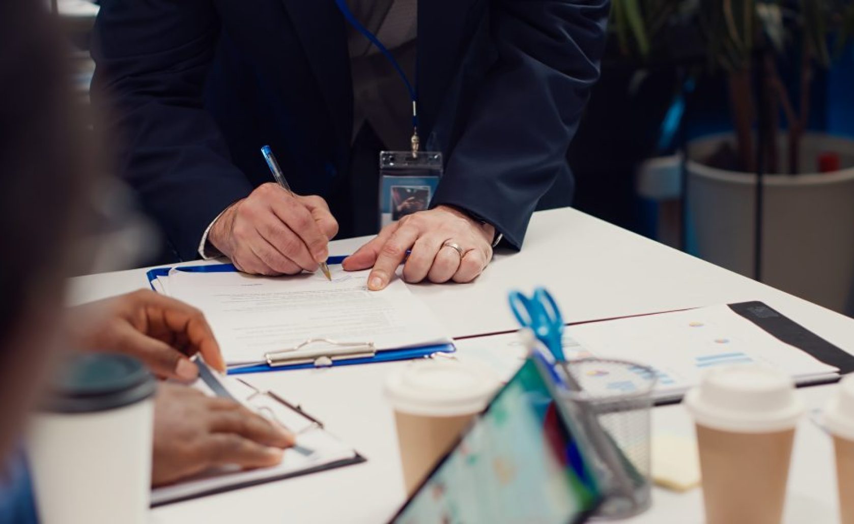 Entrepreneurs signing a new partnership contract between their firms